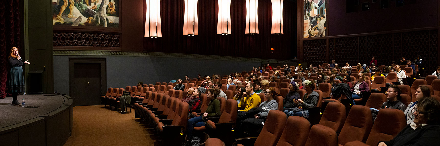 A film director speaking to an audience at IU Cinema.